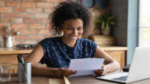happy student at home on her computer