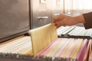 woman pulling file from cabinet