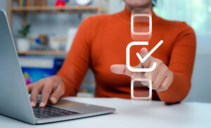 woman ticking digital box at computer