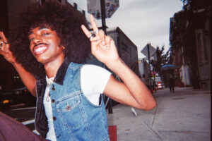 young man showing peace sign in ny