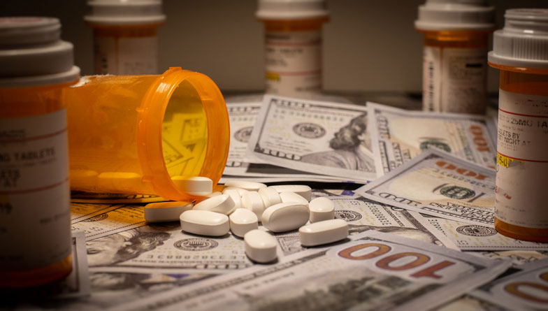 money and prescription pills and bottles on table