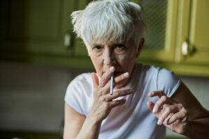 messy senior woman smoking