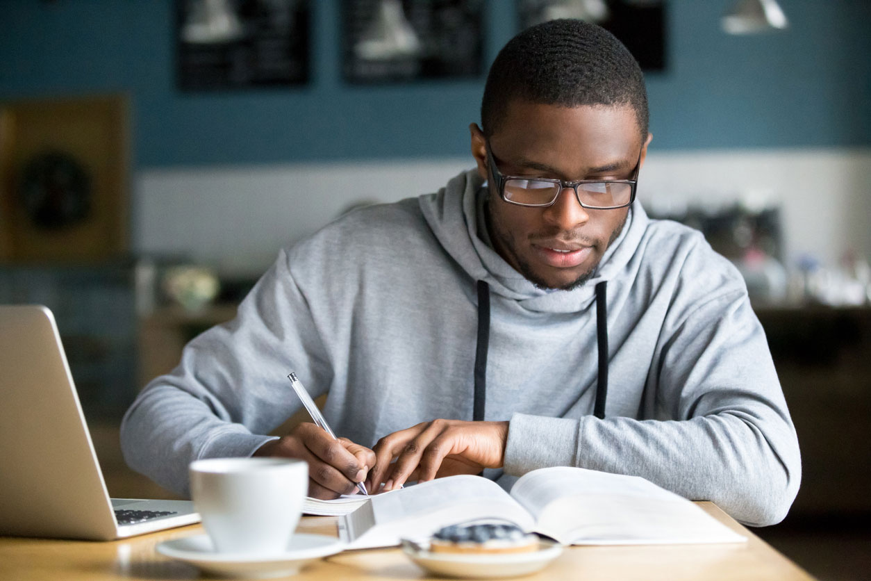 young man studying at home